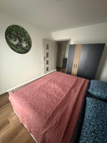 a bedroom with a bed with a red blanket on it at Apartmán LUNA Choceň in Choceň