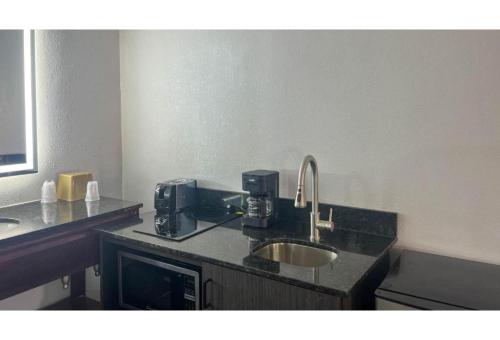 a bathroom with a sink and a counter top with a sink at Studio 6 Spindale, NC Forest City in Spindale