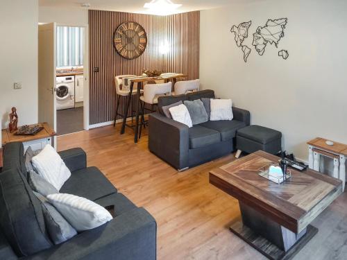 a living room with two couches and a table at Mountain View in Blaenau-Ffestiniog