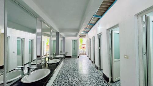 Paradise Hostel في فانغ فينغ: حمام به صف من الأحواض والمرايا