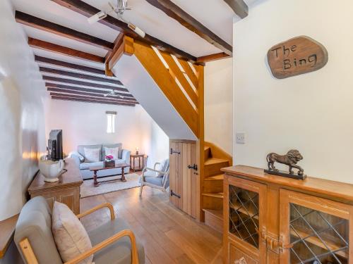 a living room with a couch and a tv at The Bing in Buckland in the Moor