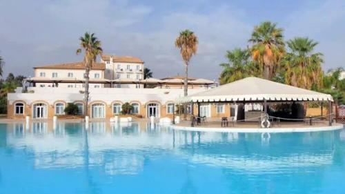 a large pool of water in front of a building at Hotel Kaos in Villaggio Pirandello