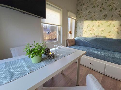 a living room with a table and a couch at Nybyggd loftstuga i centrala Grebbestad in Grebbestad