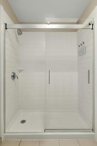 a shower with a glass door in a bathroom at Fairfield Inn & Suites Savannah I-95 South in Savannah