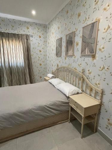 a bedroom with a bed and a table in it at Williston Bly of Gly in Williston