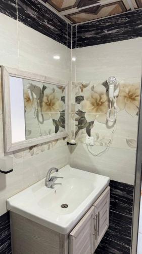 a bathroom with a sink and a mirror at Silent Sands in Wadi Rum
