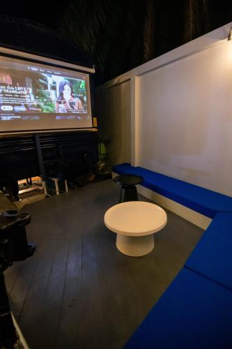 a stage with a white table and a tv at Baan Rot Fai Krabi Platform 3 in Ao Nam Mao