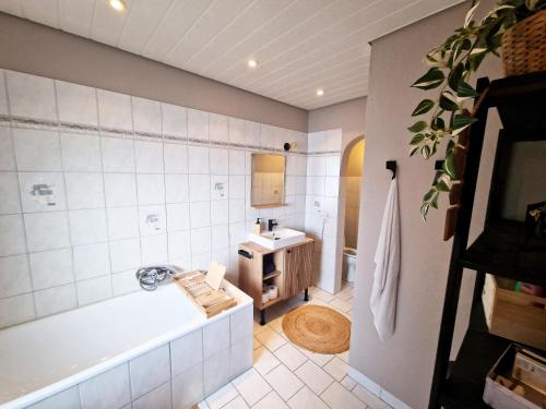 a bathroom with a bath tub and a sink at Himmelsnest in Bad Wildbad