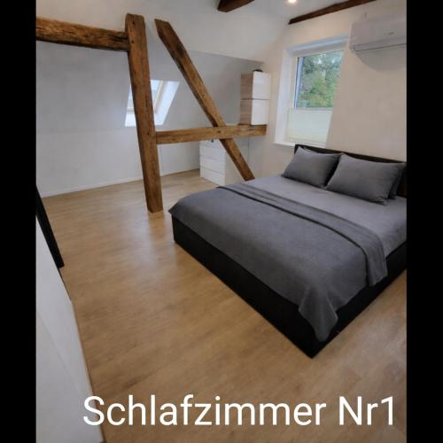 a bedroom with a bed and a window at Ferienwohnung NR4 DG Klima in Großräschen