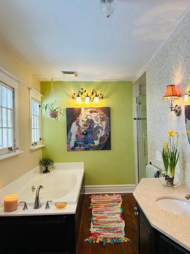 a bathroom with a bath tub and a sink at The Farmhouse Manor B&B in St. Catharines