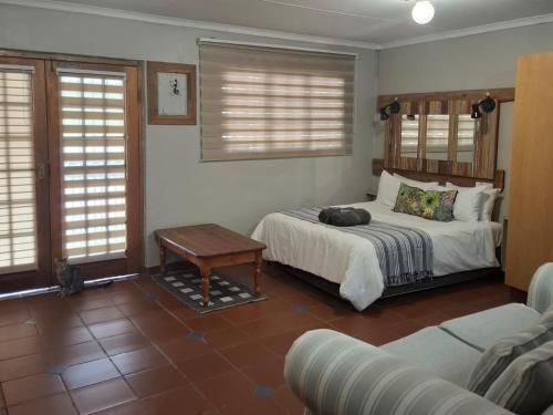 a bedroom with a bed and a couch at SomethingElz@Grace in Pretoria