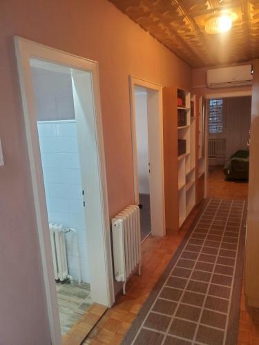 a hallway with a room with two doors and a room with at Apartment PER DAY in Vrbas
