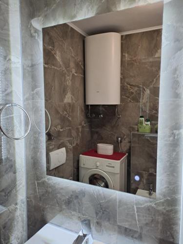 a bathroom with a washing machine in a mirror at Val in Kaštela