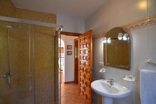 a bathroom with a shower and a sink and a mirror at Villa La Frasca with private Pool in Corumbela