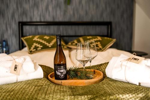 a bottle of champagne and a wine glass on a table at Dworek Modrzewiowy in Kraśnik