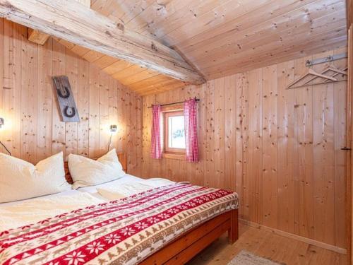 a bedroom with a bed in a wooden room at Almhütte Bairau Kaser in Lofer
