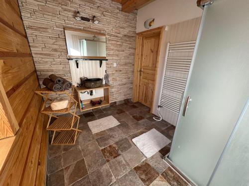 an empty room with a stone wall and a door at Roubenka Liduška in Mikulovice