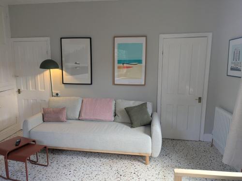 a living room with a couch and two pictures on the wall at Tranquil flat in vibrant Nether Edge in Nether Edge