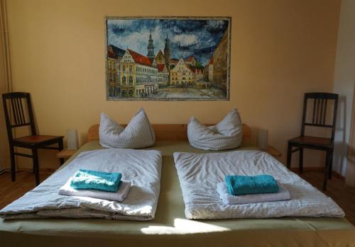 a bedroom with two beds with pillows on them at Ferien im Denkmal an der Elbe in Stadt Wehlen