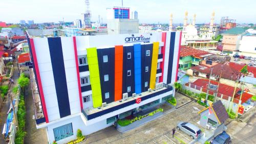 a building with colorful squares on it in a city at Amaris Hotel Pekanbaru in Pekanbaru