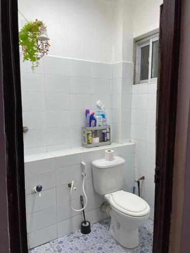 a bathroom with a white toilet in a room at Zuribreezhomes in Bamburi