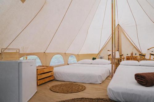 a room with three beds in a tent at Secret View Glamp - La Mariposa in Alghero