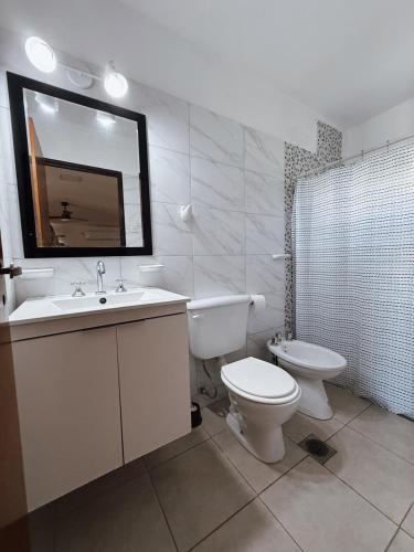 a bathroom with a sink and a toilet and a mirror at Petit Hotel Las Marias in La Rioja
