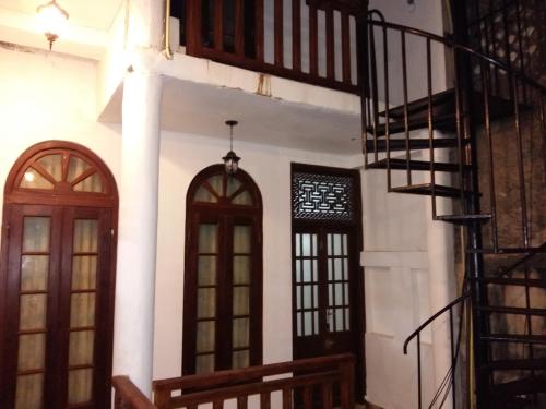 a building with two doors and a spiral staircase at Southern Comforts - Galle Fort in Galle