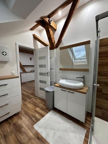 a bathroom with a sink and a mirror at PS5, VR2, Logitech racing-Apartmán pod Chočom in Leštiny