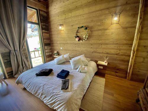 a bedroom with a bed with two bags on it at Grange de Marius - Authentique grange savoyarde in Albiez-Montrond