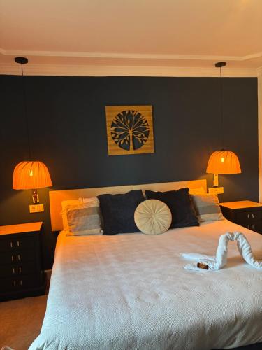 a bedroom with a large bed with two lamps at The Blue Suite in Fuengirola