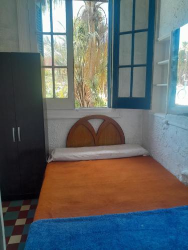 a bedroom with a large bed in a room with windows at Canela in Atlántida