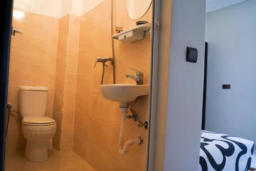 a small bathroom with a toilet and a sink at Al Mohit Hôtel Dakhla in Dakhla