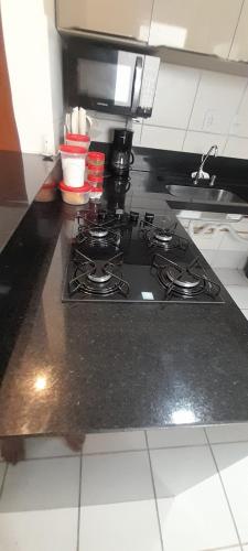 a kitchen counter with a stove top in a kitchen at Ap no Turu, 10 min das praias in São Luís