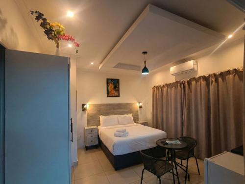 a bedroom with a bed and a table and chairs at Da Vinci - Zur See in Ballito