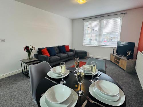 a living room with a dining table and a couch at Curwen Apartment - 2 Bedrooms - Sleeps 6 in Workington