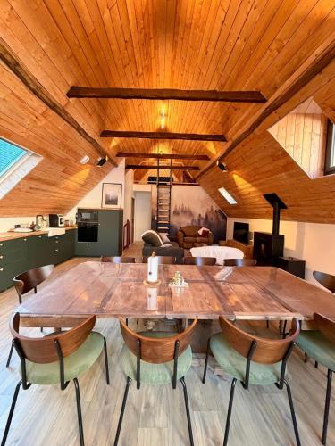 a large dining room with a large wooden table and chairs at La grange Ausar in Bareilles