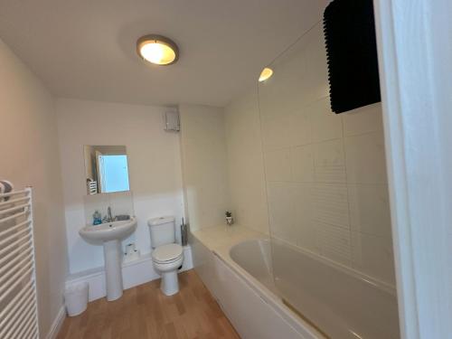 a bathroom with a toilet and a tub and a sink at Curwen Apartment - 2 Bedrooms - Sleeps 6 in Workington