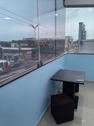 a table in a room with a view of a city at Quarto privado próximo ao centro 6 in Manaus