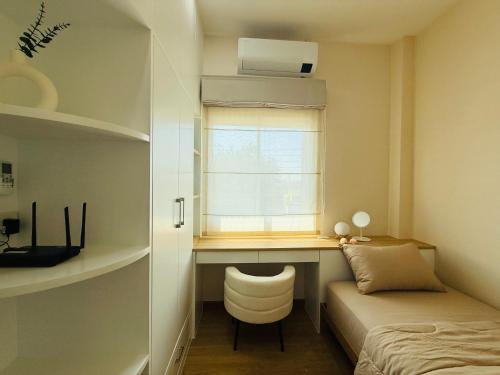 a bedroom with a desk and a bed and a window at House in HangDong in Hang Dong