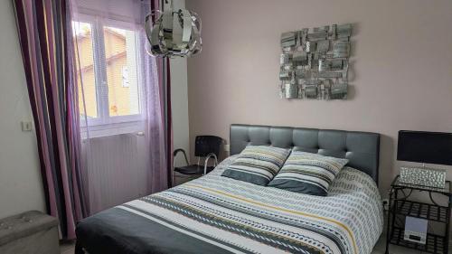 a bedroom with a bed and a window at Shanaël in Gap