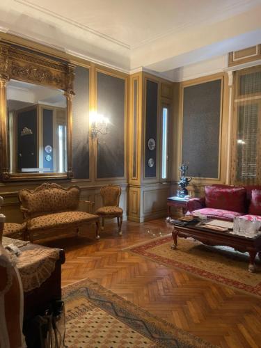 a living room with a couch and a table at Graeco-Roman Residence-Delilah in Alexandria