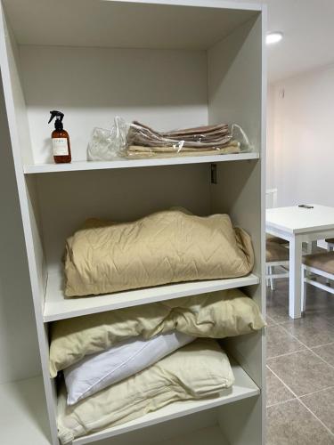 a room with shelves with pillows and a bed at Fully equipped studio apartments in Apóstoles