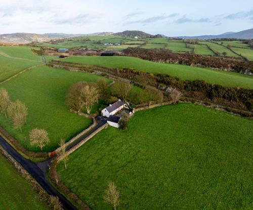 an aerial view of a farm with a barn in a field at Secluded Traditional Cottage & Hot Tub - Tosses Cottage in Newry