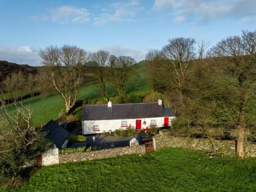 an aerial view of a house in a field at Secluded Traditional Cottage & Hot Tub - Tosses Cottage in Newry