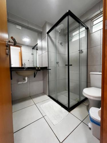 a bathroom with a glass shower and a toilet at Studio Easy West Flat in Mossoró