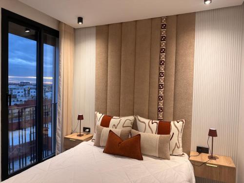 a bedroom with a large bed and a large window at Luxury Studio Casa Center in Casablanca