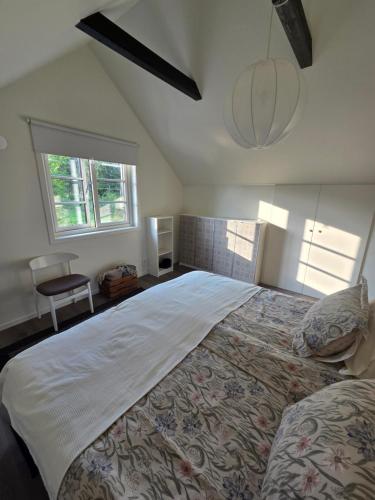 a bedroom with a large bed and a window at The little house by the paddock - only for non smokers in Gothenburg