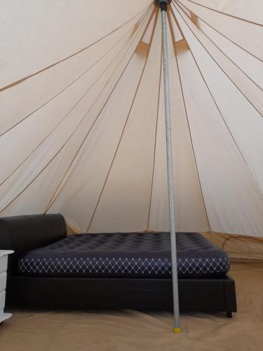 a mattress in a room with a tent at St Mullins Glamping Bell Tent in Saint Mullins