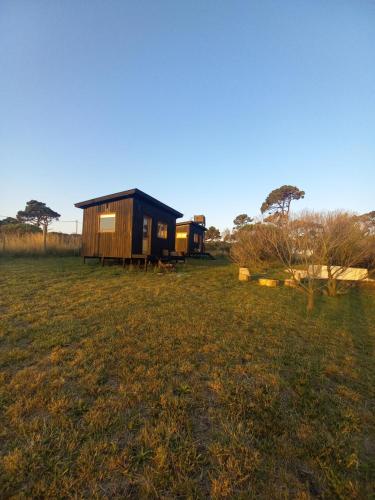 a couple of tiny houses in a field at Las Chircas Chapadmalal in Chapadmalal